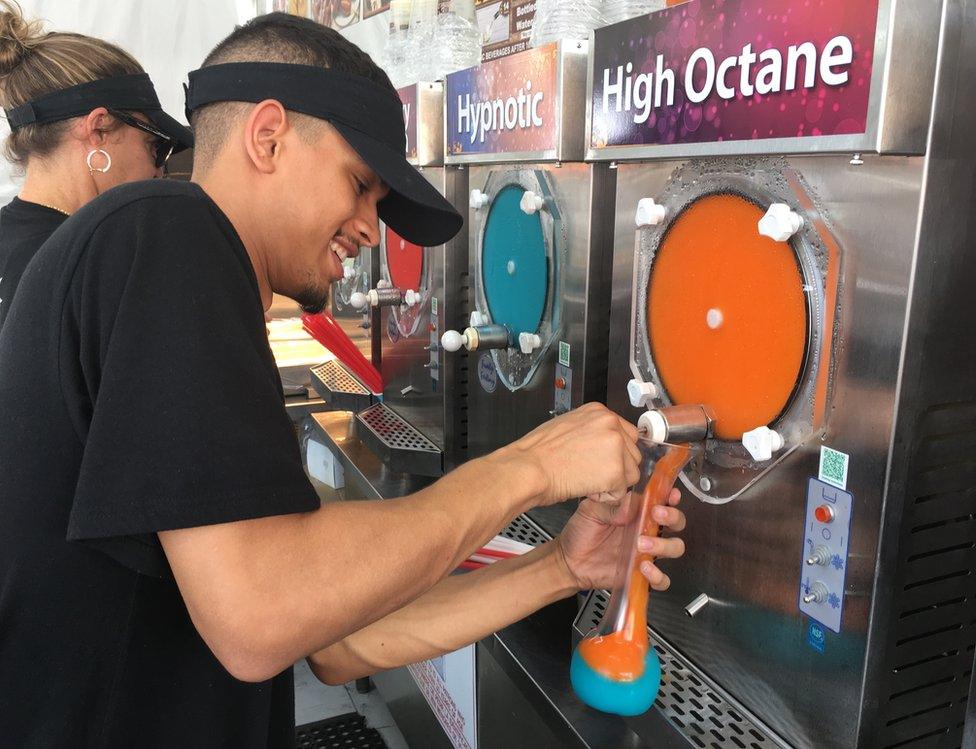 A man pours colourful frozen alcohol