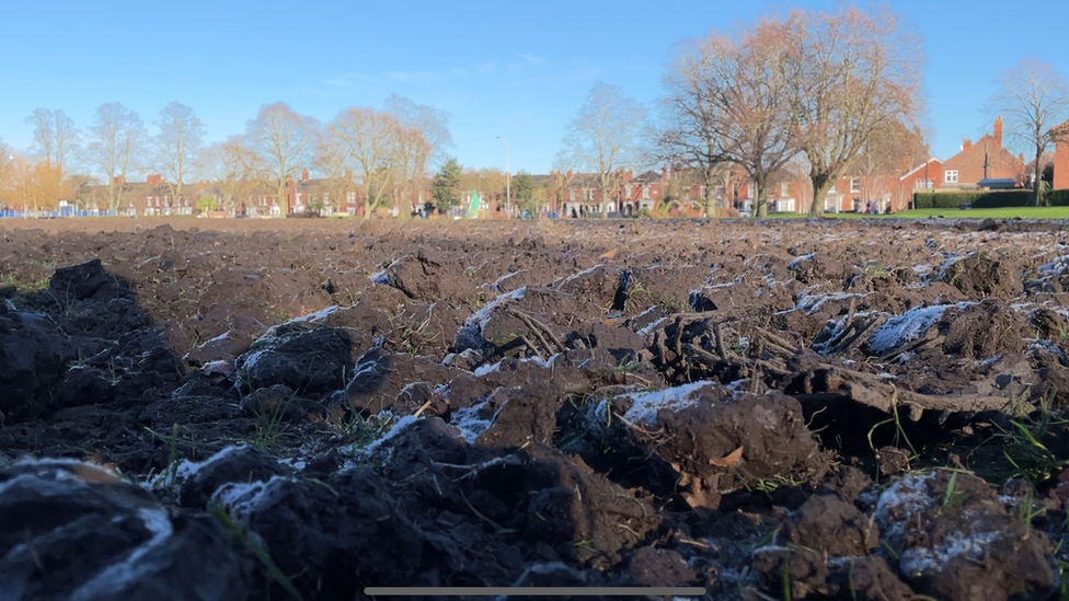 Churned up grass in Boston's Central Park.