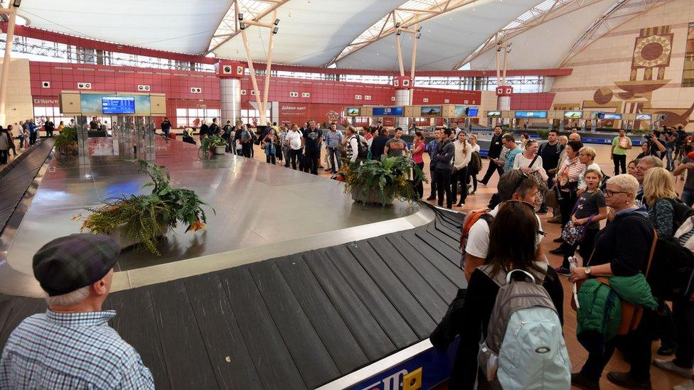 Passengers wait for their luggage at Sharm el-Sheikh international airport.