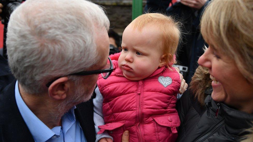 Jeremy Corbyn with a baby