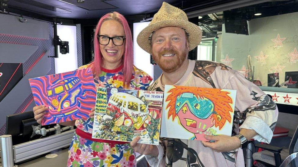 Sarah Graham and Keith Lemon holding up three paintings