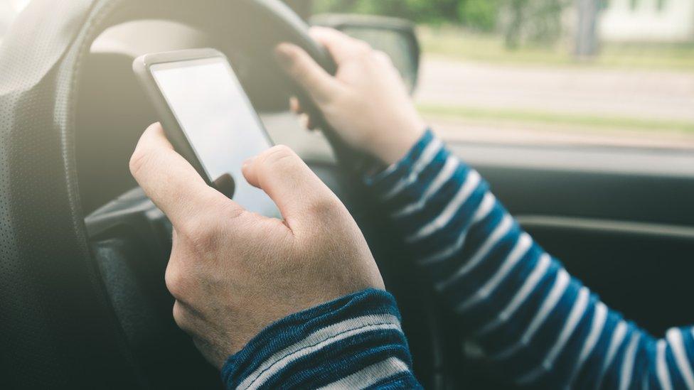 Woman using mobile phone while driving