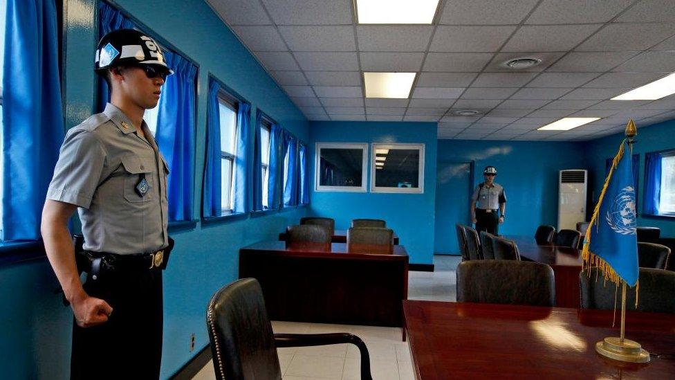 South Korean soldiers stand guard at the Military Demarcation Line in the Demilitarized Zone (DMZ) in the border village of Panmunjom, South Korea, 23 July 2014.