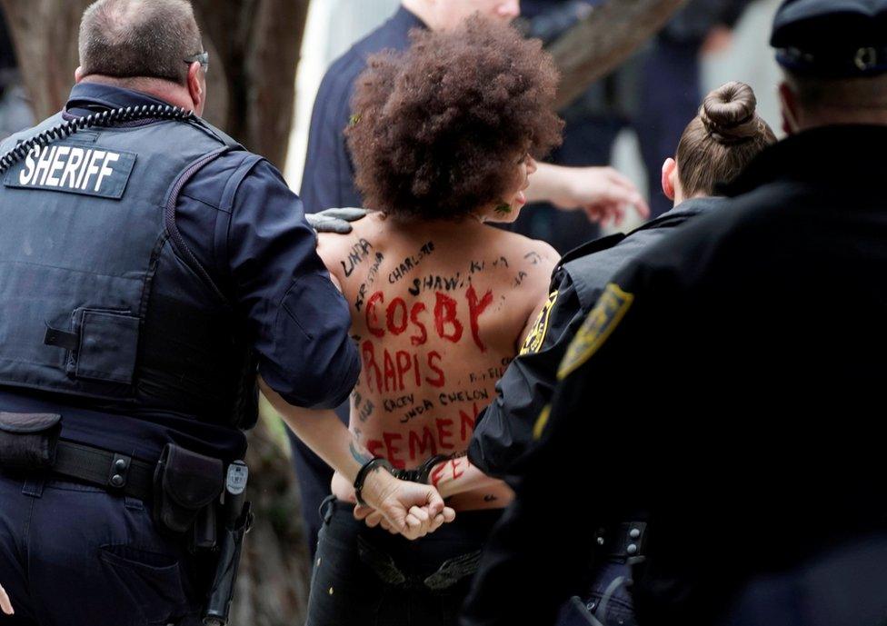 A protester is escorted out by the the police after breaking through the barriers.