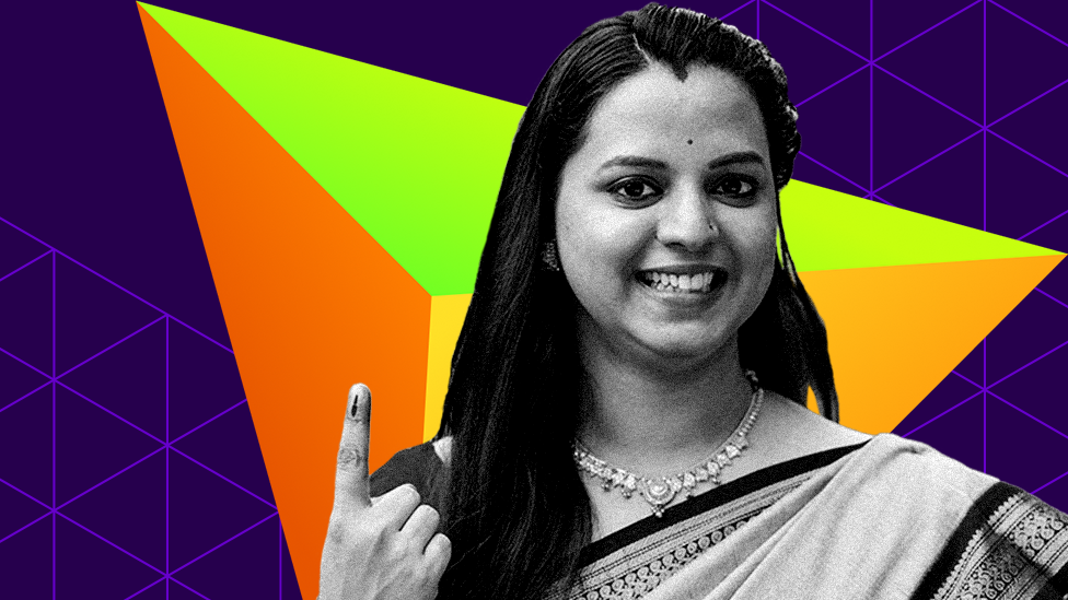 A young woman shows her ink-marked finger after casting her vote