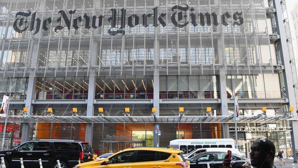 In this file photo a man holds his smartphone in front of the New York Times building on September 6, 2018 in New York