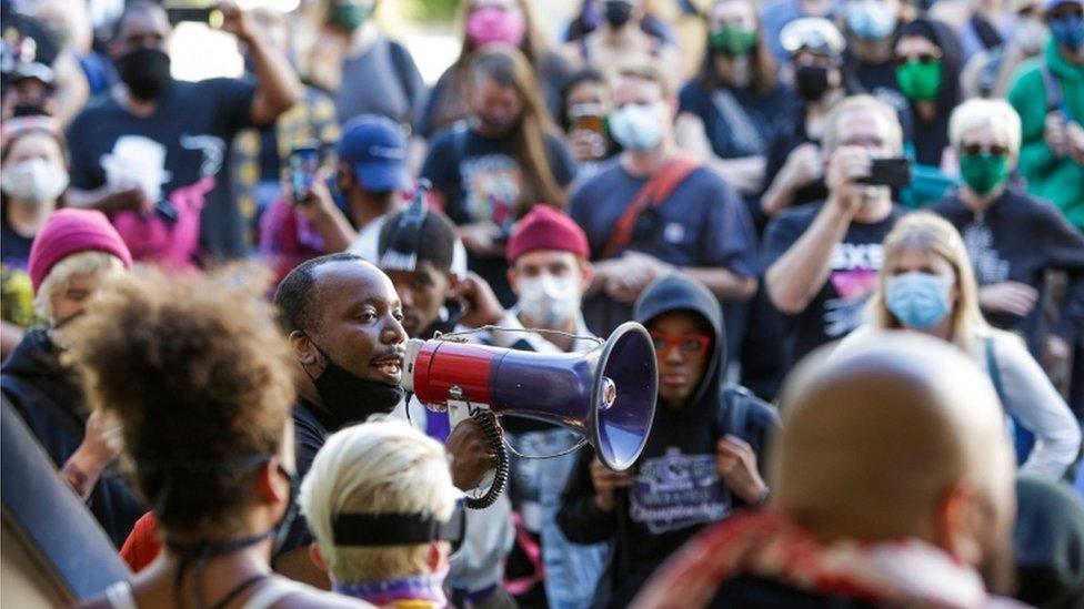 Mark Henry Jr. of Black Lives Matter addresses a crowd in the Chaz