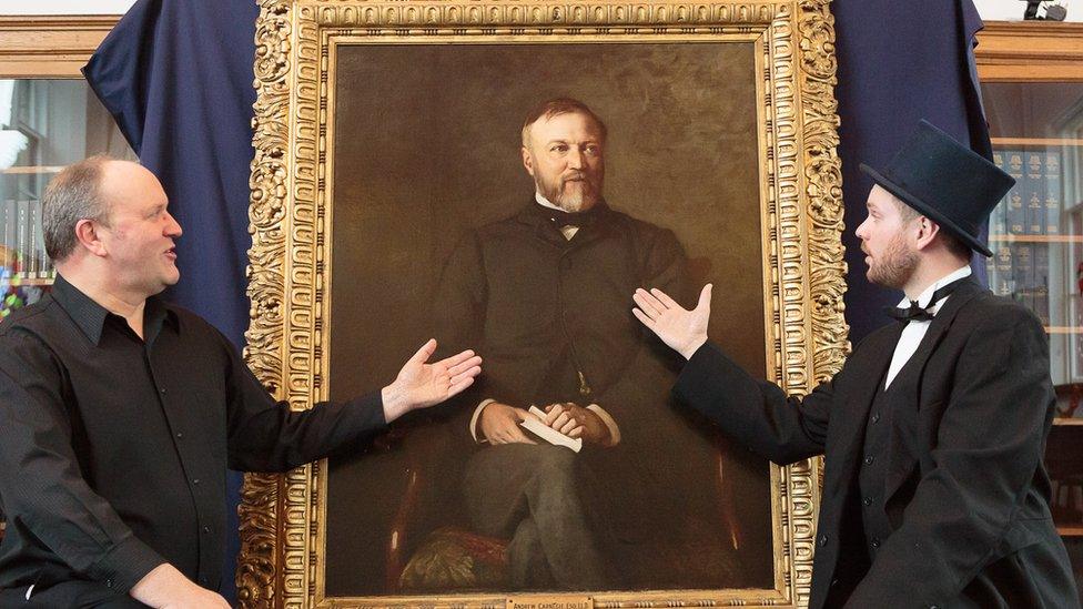 Ian Hammond Brown and Joe Whiteman with a portrait of Andrew Carnegie