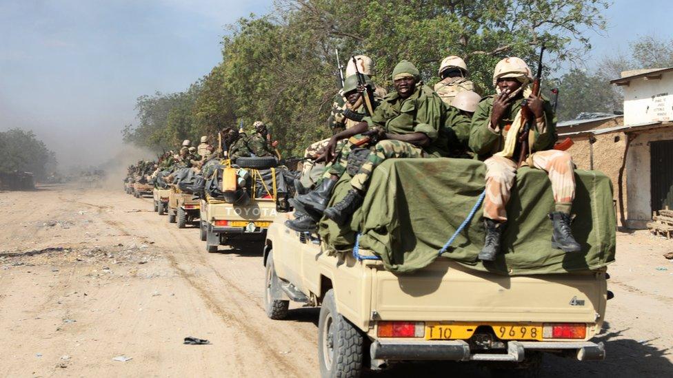 Chadian soldiers patrol in the Nigerian border town of Gamburo