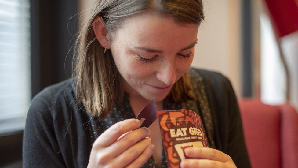 Becky looking at the packet of crickets