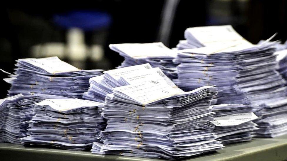 Ballot papers stacked up