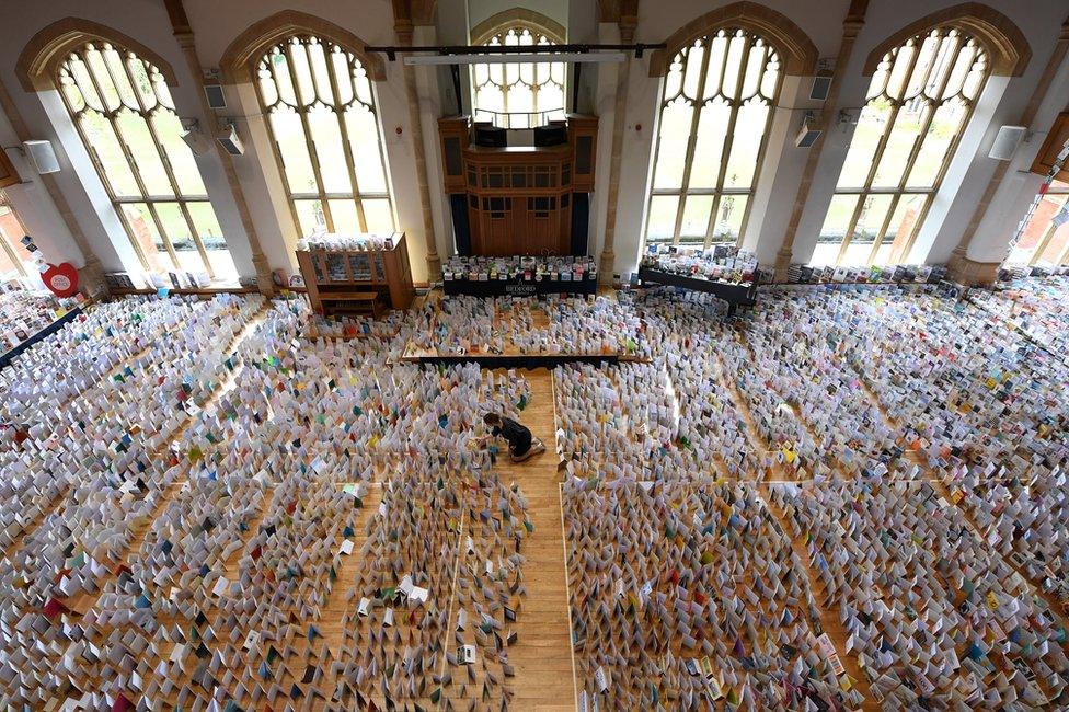 A view of thousands of birthday cards laid out in a large hall