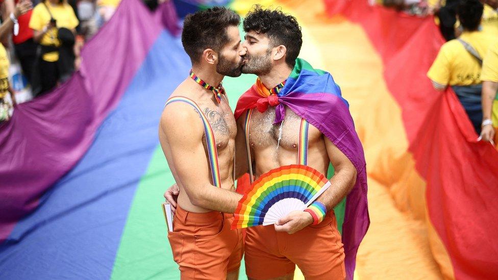 People kiss, while taking part in the 2022 Pride Parade in London,