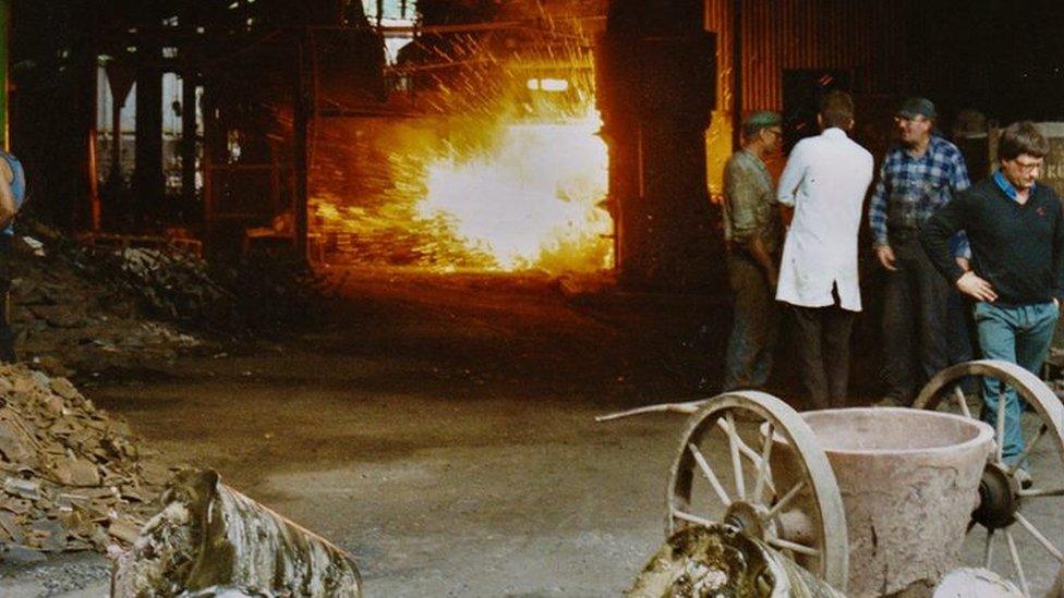 Workers inside the foundry