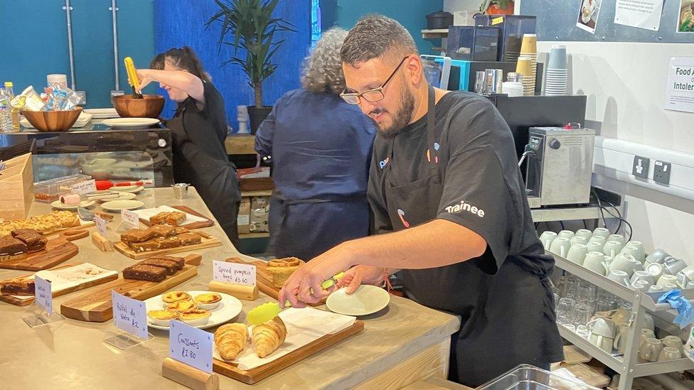 A photo of Mr Wride working in the cafe