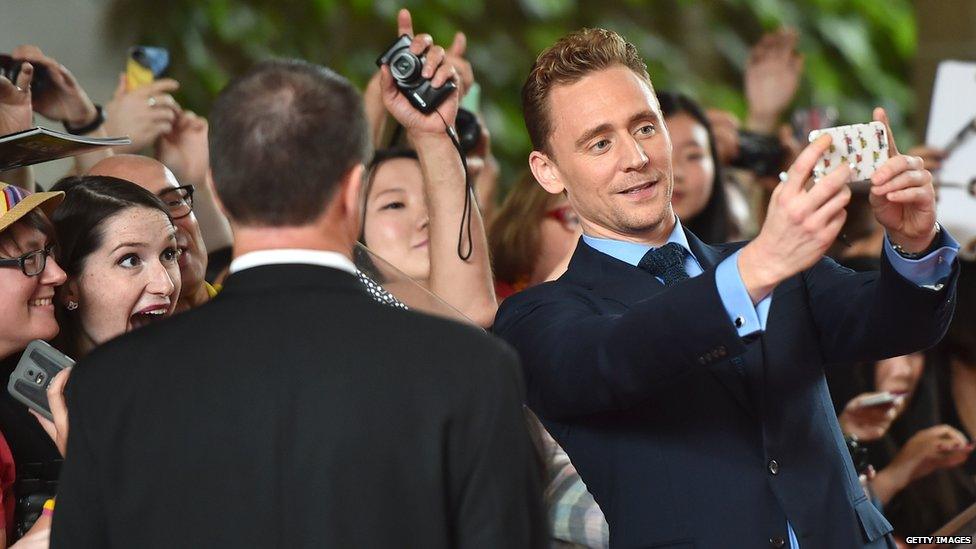 Tom Hiddleston takes a selfie photo with an excited fan at the recent Toronto International Film Festival