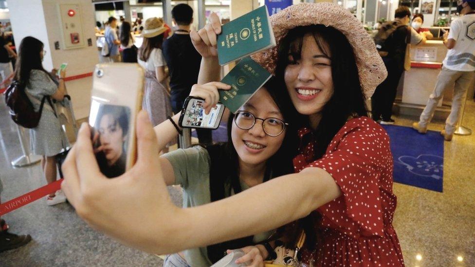 two-girls-pose-for-photo-at-airport.