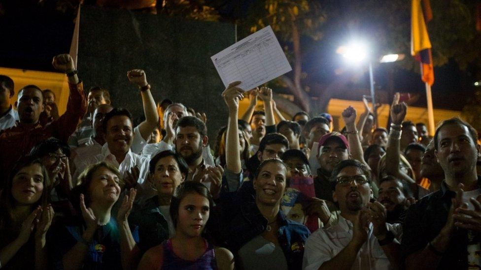 Diana Lopez (C), sister of jailed Venezuelan opposition leader Leopoldo Lopez, shows a document signed by her brother as part of the process to request a recall referendum on Venezuelan President Nicolas Maduro, in Caracas, Venezuela, 29 April 2016. Leopoldo Lopez signed the document as a first step calling for a referendum to reduce the mandate of President Maduro. EPA/