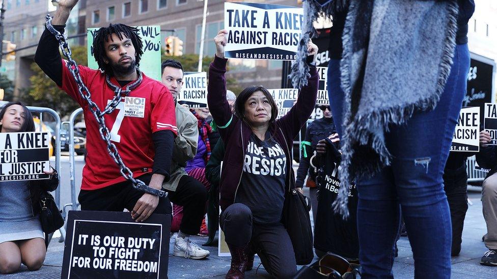 Protestors hold a demo outside an NFL meeting in New York, 2017