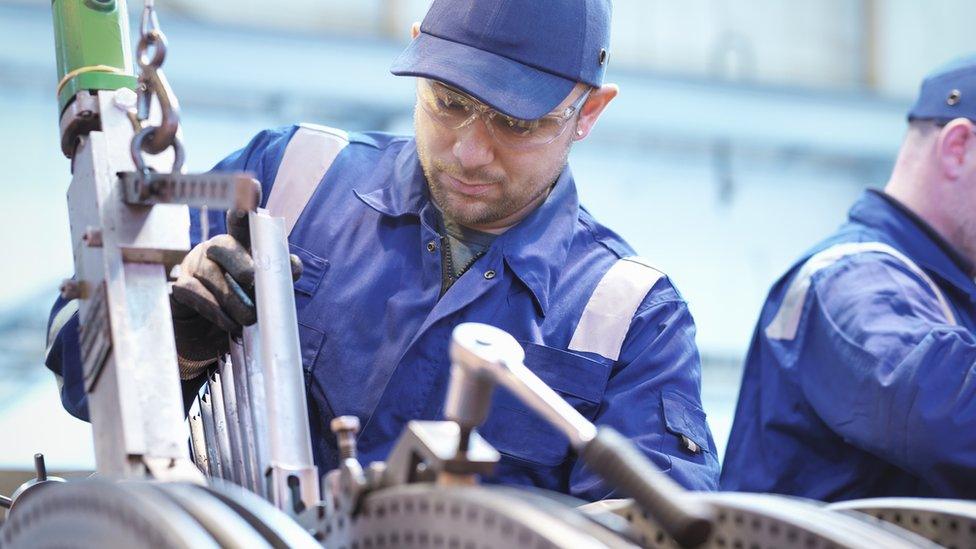 Generic image of a man working in a metal workshop