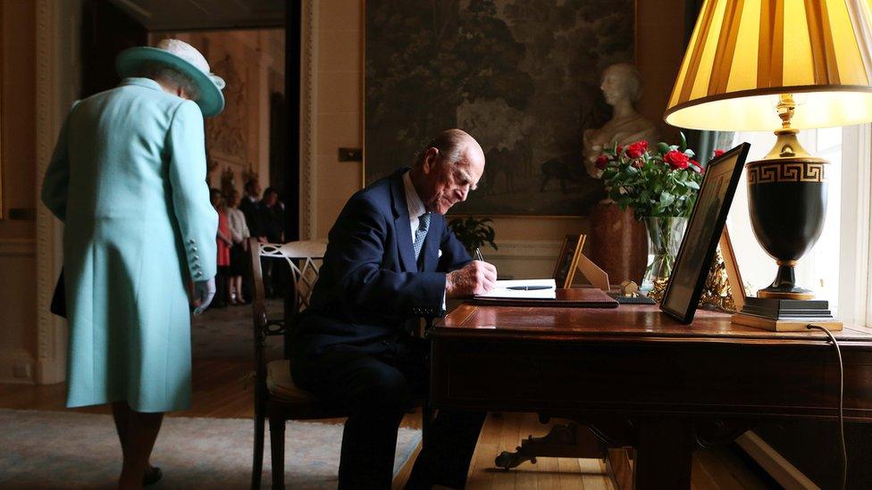 The Duke of Edinburgh signs the visitors book at Hillsborough Castle