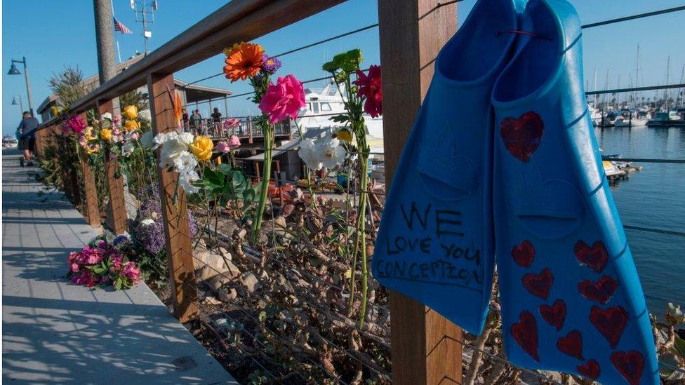 A pair of diving fins and flowers at a memorial wall near the Truth Aquatics moorings where the boat that burned and sank off the Santa Cruz islands early in the morning, was based in Santa Barbara, California