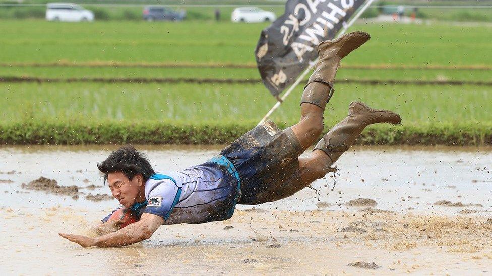 Ryoma Shirai scores a mud-splattered try at a tambo tournament in Chiba