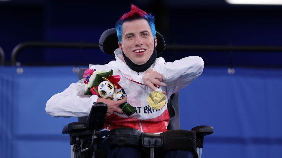 david-smith-smiles-with-his-gold-medal