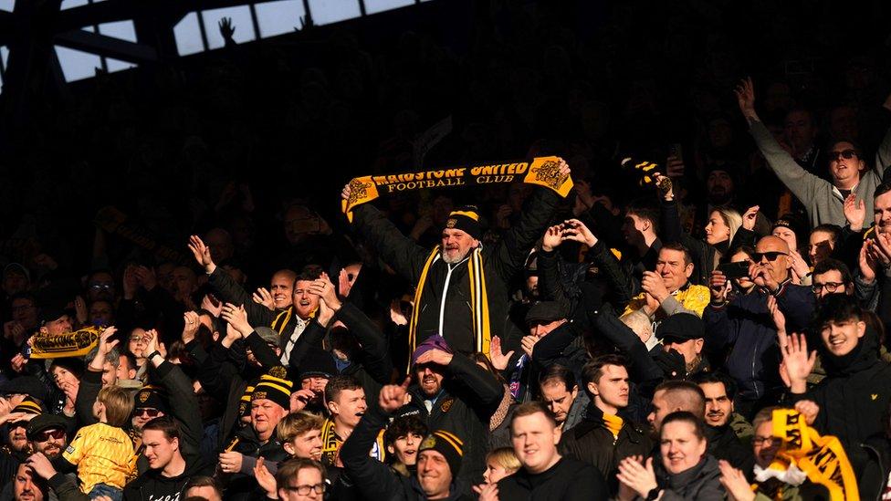 Maidstone United fans celebrating the full-time win at Ipswich Town