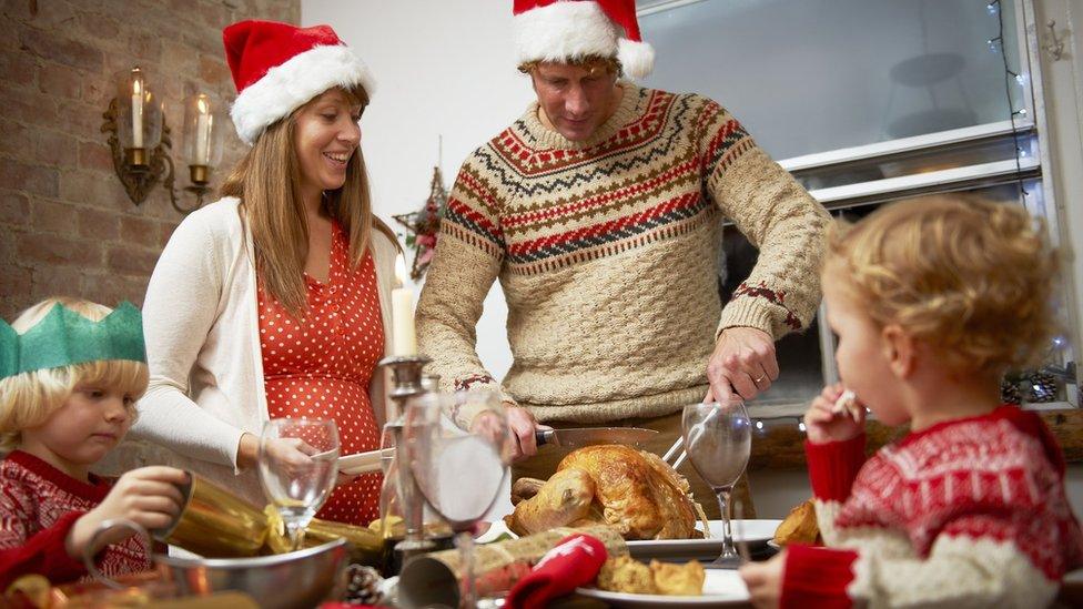 Family of four having Christmas dinner