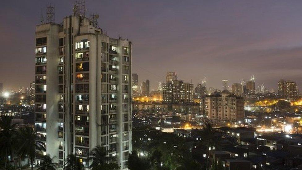 A high-rise residential tower is seen next to shanties in Dharavi, one of Asia"s largest slums, in Mumbai March 18, 2015. In Mumbai, the windows of new high-rise apartment blocks, old low-rise residential buildings and shantytown shacks portray the disparity in living conditions and incomes in the Indian city.