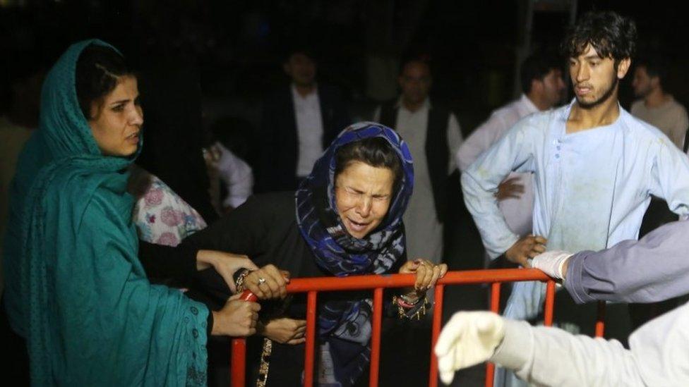 Relatives outside a hospital in Kabul last August