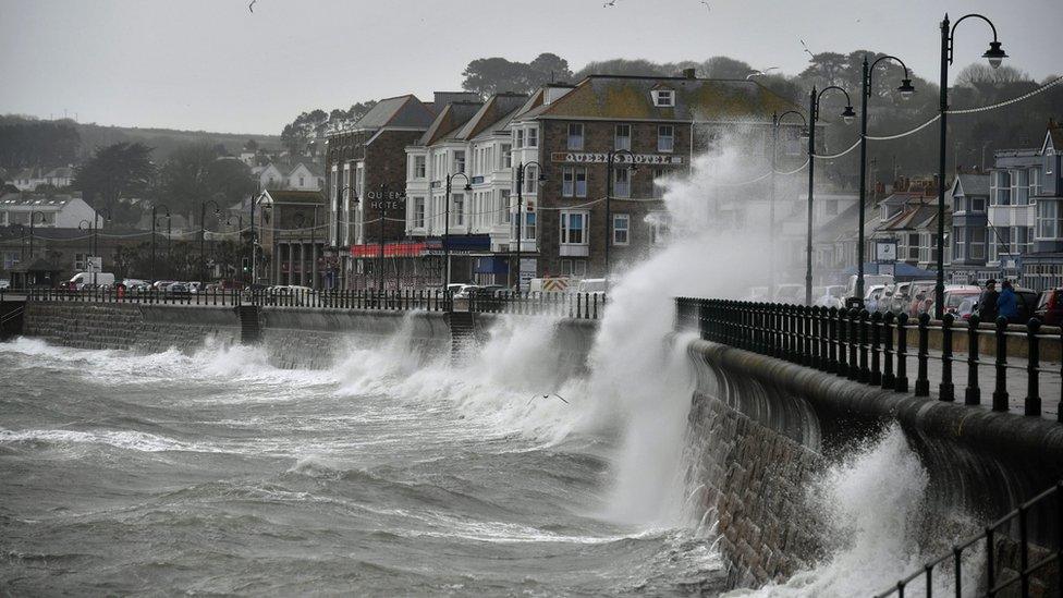 Waves crashing against the harbour wall in Penzance, Cornwall