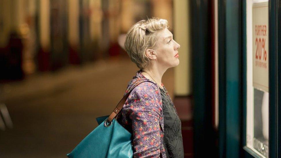 Woman looking in shop window