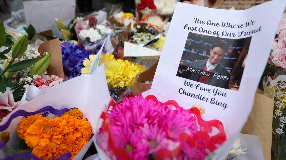 A makeshift memorial for actor Matthew Perry, the wise-cracking co-star of the 1990s hit television sitcom "Friends," who was found dead at his Los Angeles home October 28, is pictured on Bedford Street in Manhattan in New York City