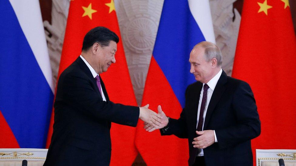 Xi Jinping and Vladimir Putin shaking hands