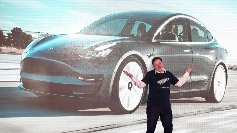 Tesla CEO Elon Musk gestures during the Tesla China-made Model 3 Delivery Ceremony in Shanghai.