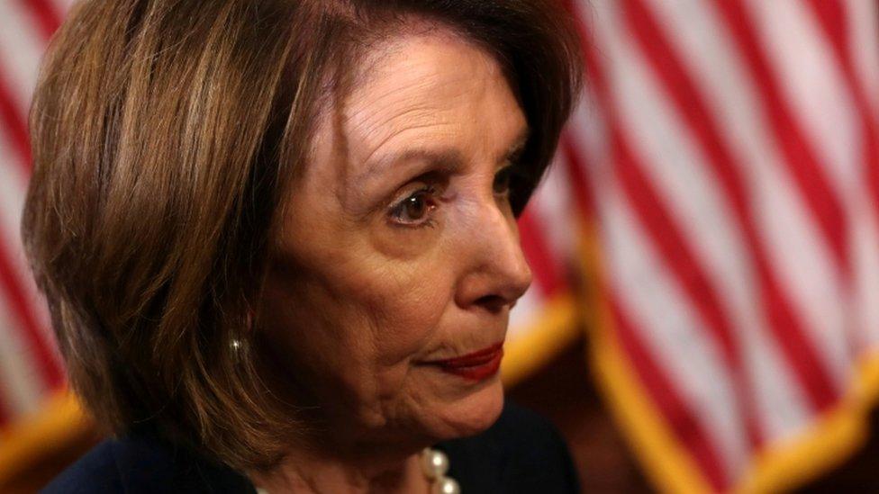 House Speaker Nancy Pelosi speaks with an aide after a news conference on proposed healthcare legislation at the Capitol in Washington, May 15, 2019