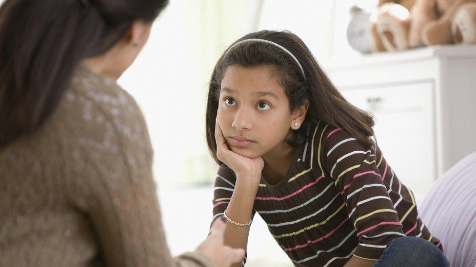 A stock photo of a mother and daughter talking