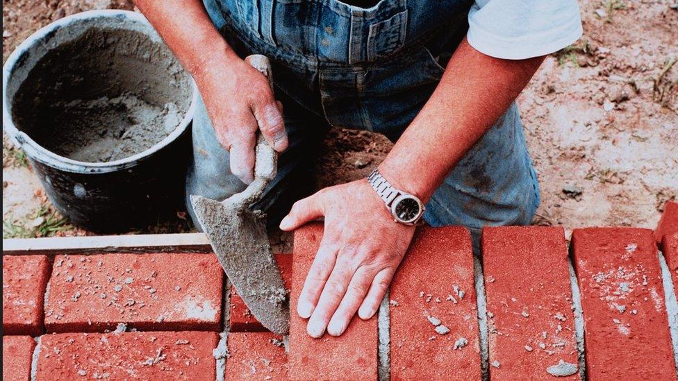 Bricklayer laying bricks