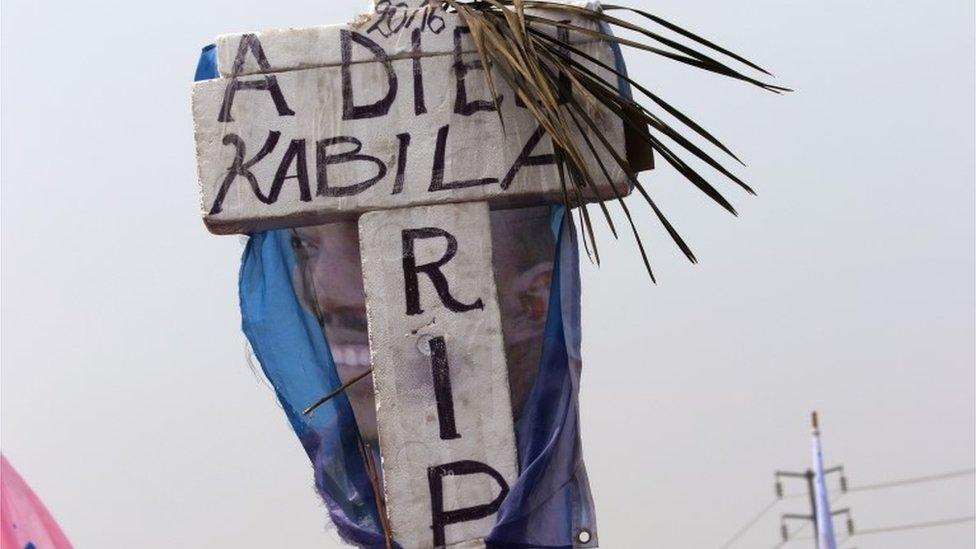 Supporters of Congo opposition leader Etienne Tshisekedi, hold up an cross that symbolizes no third term for Congo President Joseph Kabila, during a political rally in Kinshasa, Congo, Wednesday, July 31, 2016