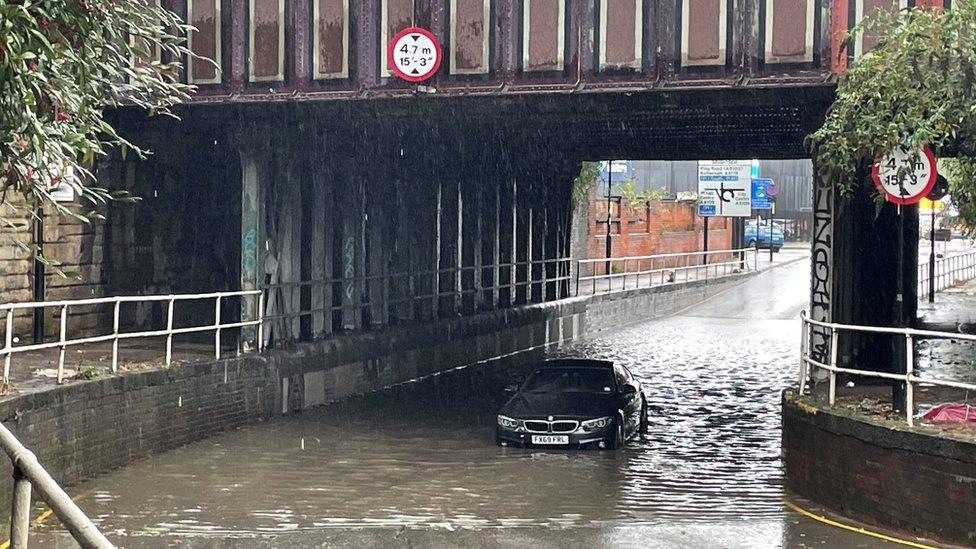 A car stuck in flood water under a railway bridge in Sheffield