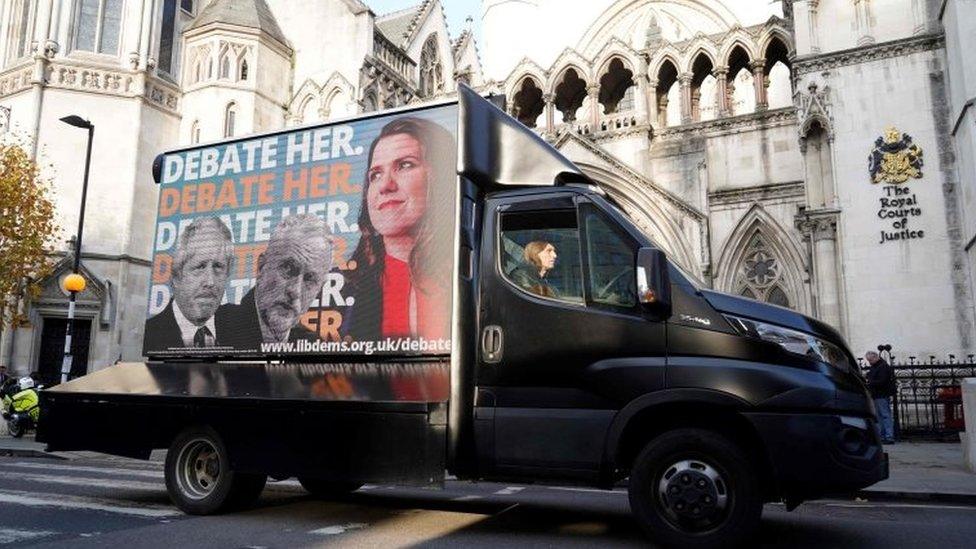 A Liberal Democrat advertising van drives past the High Court in London