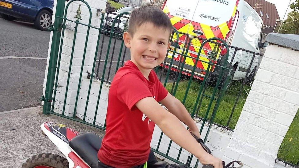 Bradley, pictured smiling and sat on a bike, was walking with a friend when he was injured