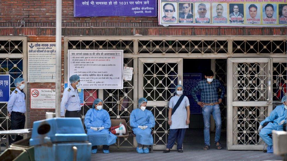 Doctors and other medical staff seen in PPE outside emergency ward on day nineteen of the 21-day nationwide lockdown to check the spread of coronavirus, outside Lok Nayak Jai Prakash Narayan (LNJP) Hospital, on April 12, 2020 in New Delhi, India.