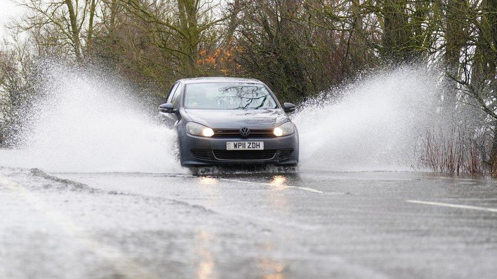 Car driving through floods