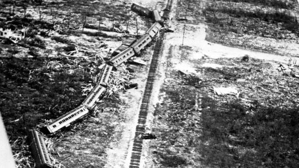 black and white image of train derailed.