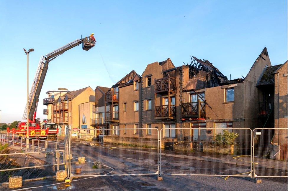 Fire-damaged flats at Nairn Harbour