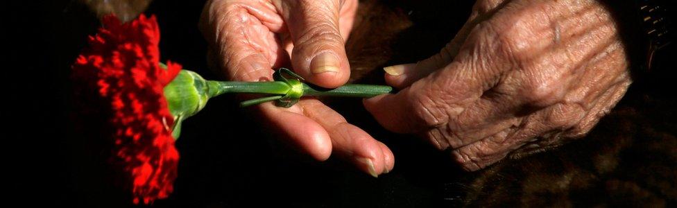 Ascension Mendieta, daughter of Timoteo Mendieta, who was shot in 1939, holds a carnation during the exhumation of her father's remains at Guadalajara's cemetery, Spain, 30 January 2016