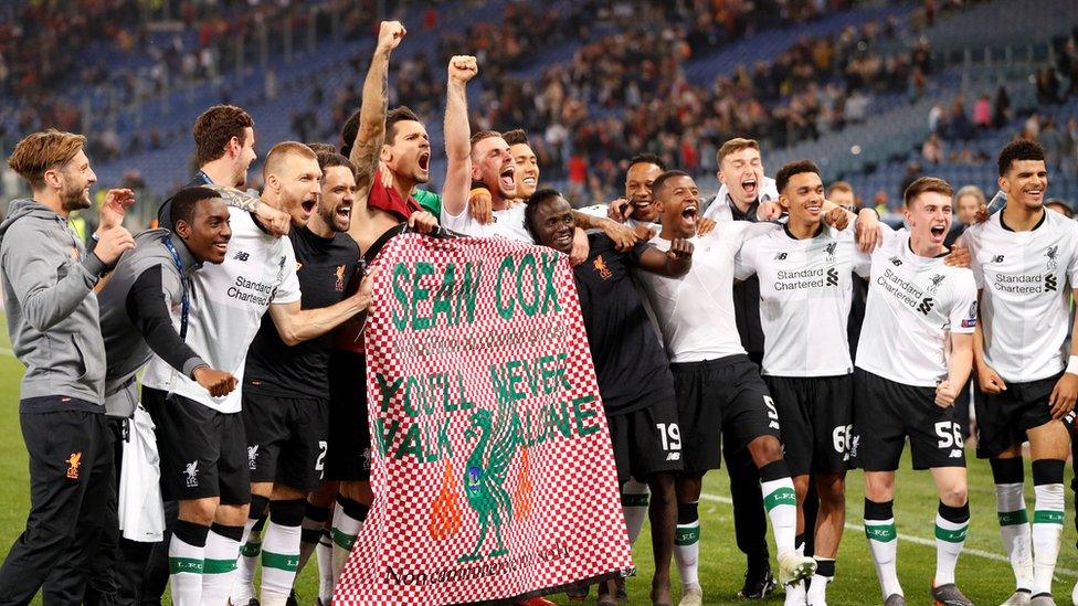 Liverpool players display a banner for fan Sean Cox as they celebrate after a match